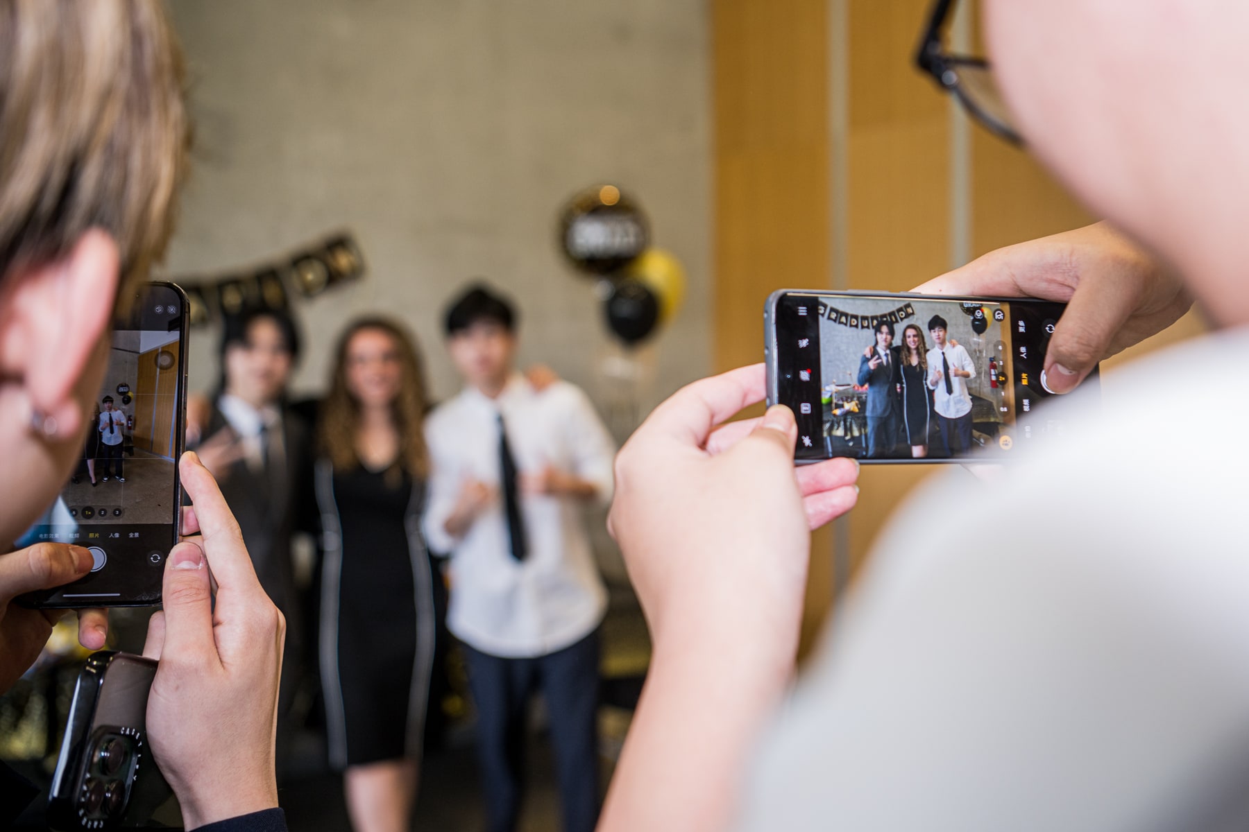 Students and teachers being photographed at a graduation event